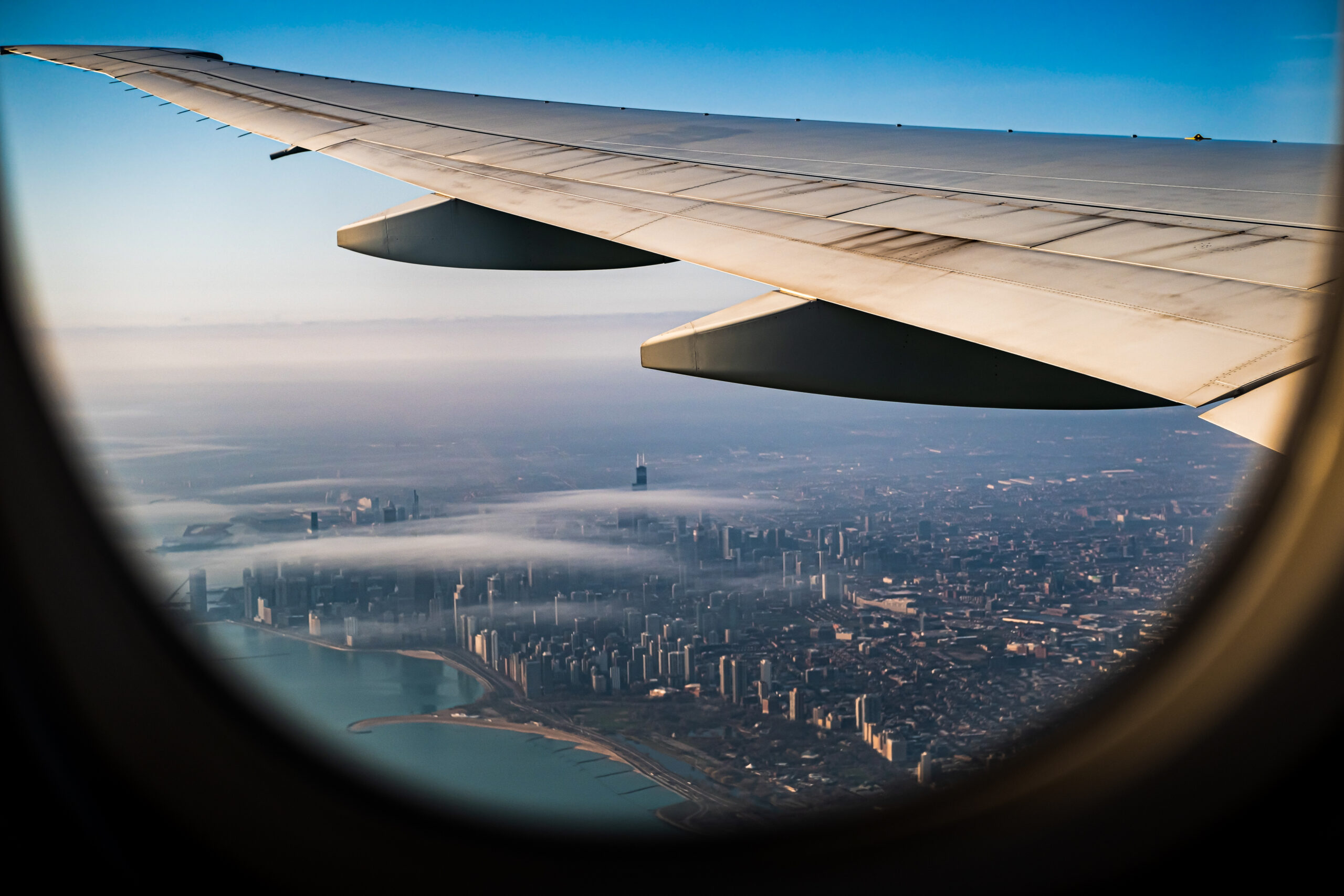 View of downtown Chicago from an airplane window, representing travel for private rehab in Chicago.