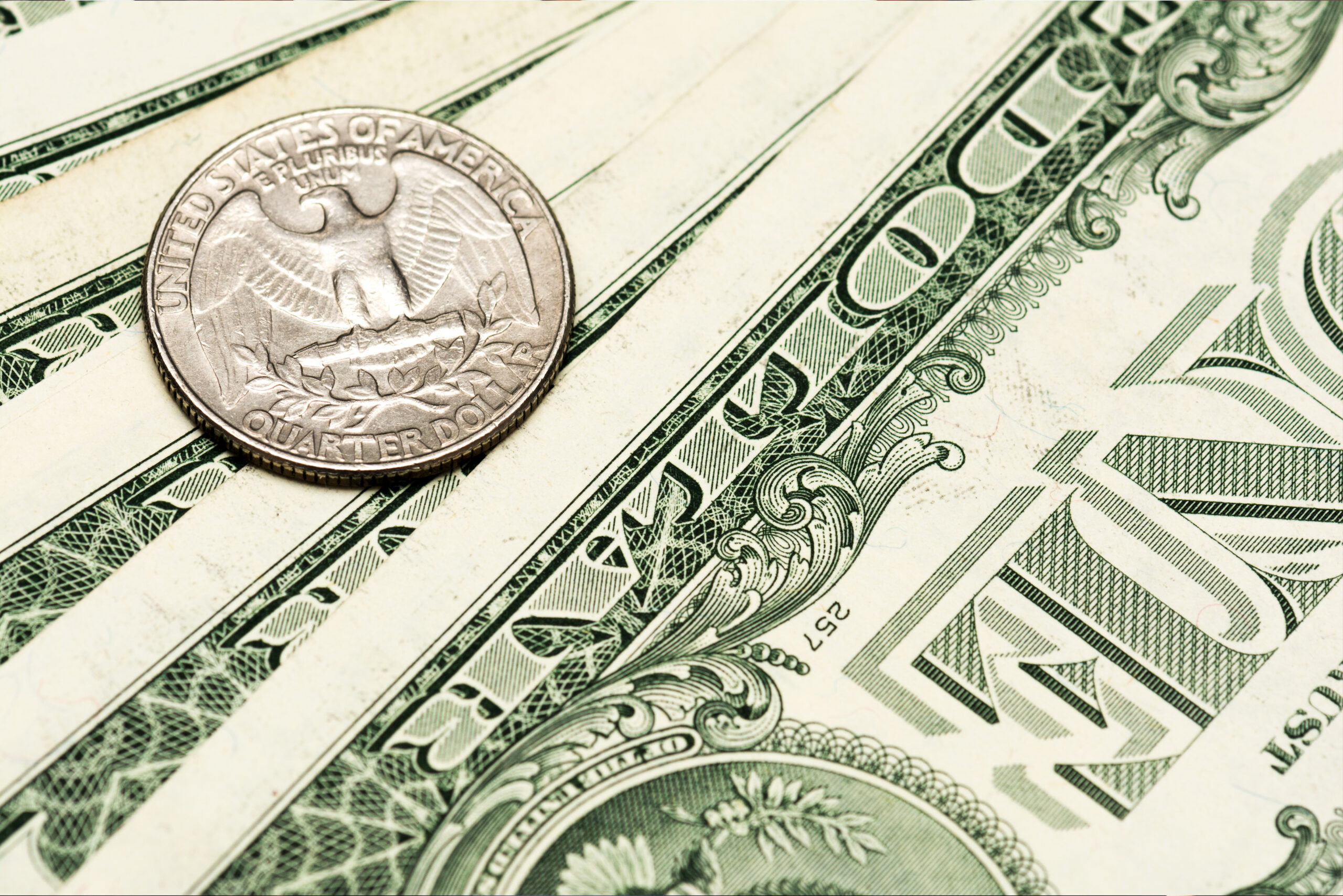 U.S. dollar bills and a coin symbolizing rehab abroad cost and how international rehab pricing compares to domestic treatment.