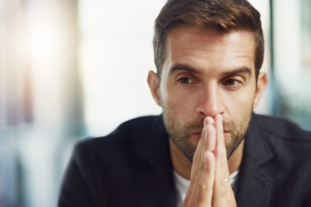 A man reflecting on addiction denial and struggling to acknowledge a substance use problem